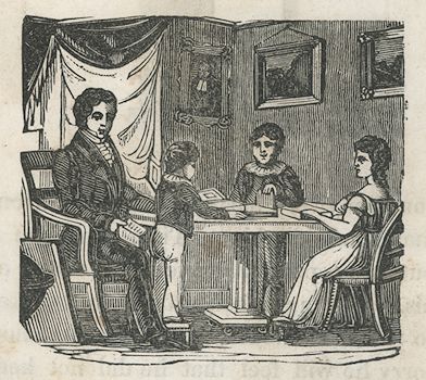 a man, a girl, and two boys sit or stand around a table