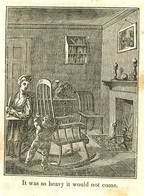 a little boy pushes a big rocking chair