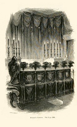 a coffin draped in black