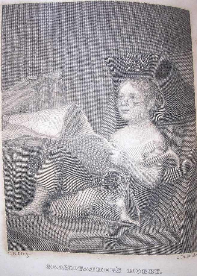 a white child wears a three-cornered hat and pretends to read a newspaper