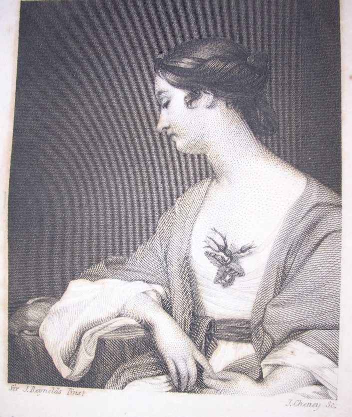 a young white woman sits pensively